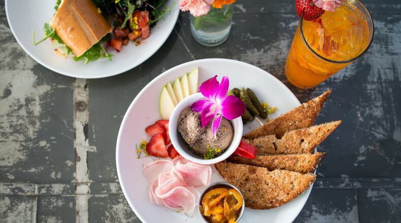 Petit Chou Chicken Liver Mousse with house preserves, toast, radishes, cornichons, pink lady apples, and Turmeric Strawberry Limeade. Photo credit- Mia Yakel.