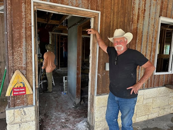 Volunteer Dave Calame stands outside a home he is helping clean after flooding in Comfort, Texas, on Saturday, July 12, 2025. (AP Photo/Gabriela Aoun Angueira)