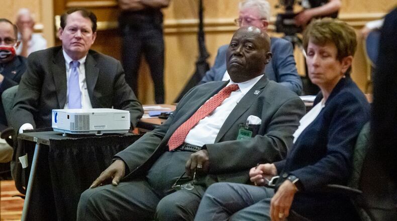 The Reverend Abraham Mosley (center) listens to Bill Stephens give a presentation during a Stone Mountain Memorial Association meeting Monday at the Evergreen Conference Center at Stone Mountain Park.  STEVE SCHAEFER FOR THE ATLANTA JOURNAL-CONSTITUTION