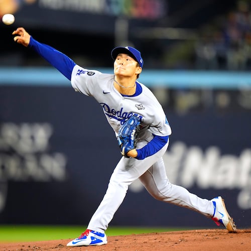 Los Angeles Dodgers pitcher Yoshinobu Yamamoto (18) delivers against the Toronto Blue Jays during the first inning in Game 2 of baseball's World Series, Saturday, Oct. 25, 2025, in Toronto. (Frank Gunn/The Canadian Press via AP)