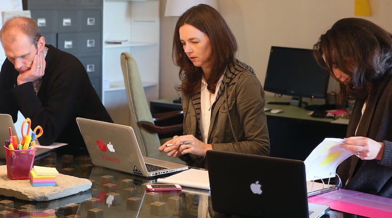 Dec. 18, 2013 - Atlanta - Chris McIlvoy (from left), Chief Technology Officer, Dr. Lucienne Ide, and Jennifer Ide, General Counsel, prepare for a conference call meeting at there office space in Atlanta. Dr. Lucie Ide’s company hasn’t yet made its first dollar, but she and her team at Rimidi have a mobile app and software they say could combat the diabetes epidemic. Atlanta needs companies like Ide’s to succeed at raising capital to attract more venture investors to help cultivate the region’s next great generation of companies. BOB ANDRES / BANDRES@AJC.COM