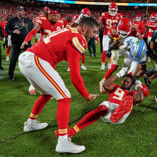 Detroit Lions defensive back Brian Branch (32) fights with Kansas City Chiefs wide receiver JuJu Smith-Schuster (9) while be held back by Chiefs' James Winchester, left, and Isiah Pacheco (10) following an NFL football game Sunday, Oct. 12, 2025, in Kansas City, Mo. (AP Photo/Ed Zurga)