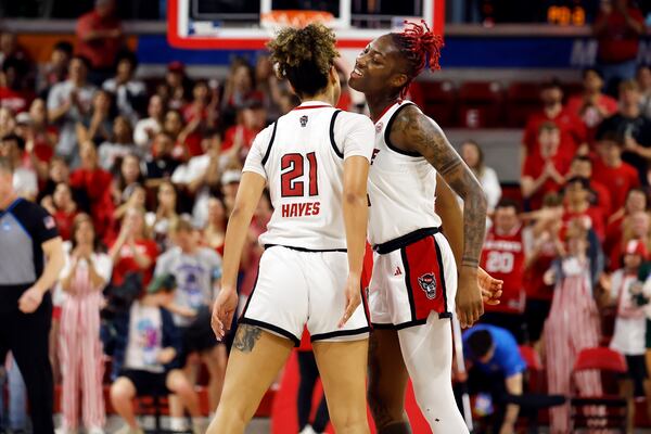 North Carolina State's Saniya Rivers, right, celebrates with teammate Madison Hayes (21) during the first half against Michigan State in the second round of the NCAA college basketball tournament in Raleigh, N.C., Monday, March 24, 2025. (AP Photo/Karl DeBlaker)