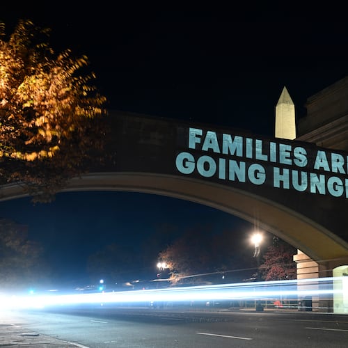 A message from the National Women's Law Center concerning the announcement by the Trump administration of restoring only half funding the SNAP benefits is projected on the U.S. Department of Agriculture building, Monday, Nov. 3, 2025, in Washington. (AP Photo/John McDonnell)