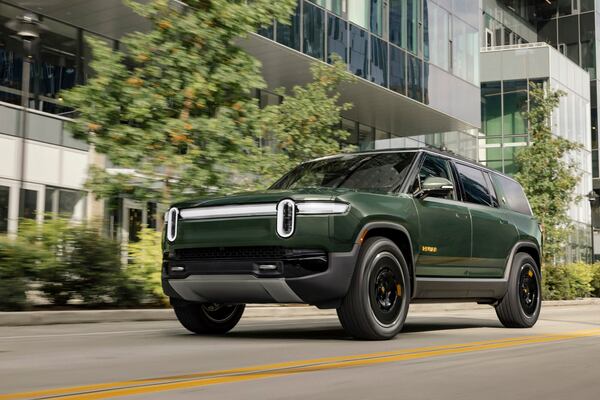This photo provided by Rivian shows the 2025 R1S. The R1S is a practical SUV that also looks tough and is impressively capable off-road. (Courtesy of Rivian Automotive via AP)