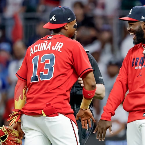 Atlanta Braves' Ronald Acuna Jr. (13) and Michael Harris II, right, celebrate after their team defeated the Philadelphia Phillies in a baseball game, Friday, April 24, 2026, in Atlanta. (AP Photo/Erik S. Lesser)