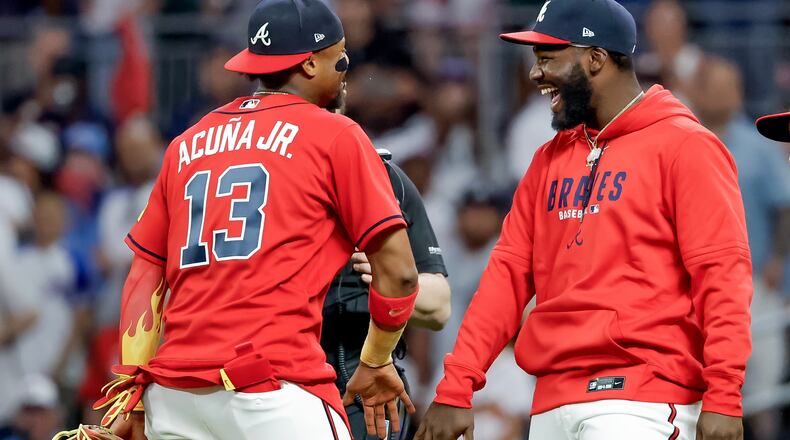 Atlanta Braves' Ronald Acuna Jr. (13) and Michael Harris II, right, celebrate after their team defeated the Philadelphia Phillies in a baseball game, Friday, April 24, 2026, in Atlanta. (AP Photo/Erik S. Lesser)