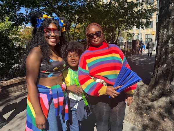 Deekayla Thomas (right), 25, from Fairburn with her sister, Kandra Thomas (left) and 8-year-old nephew. Kandra came to celebrate her sister, who came out when she was 16. "It's important to show unity," she said. (Danielle Charbonneau/AJC)
