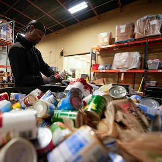Volunteer Matthew Underwool works at MUST Ministries food distribution center, Monday, Nov. 3, 2025, in Marietta. (Mike Stewart/AP)