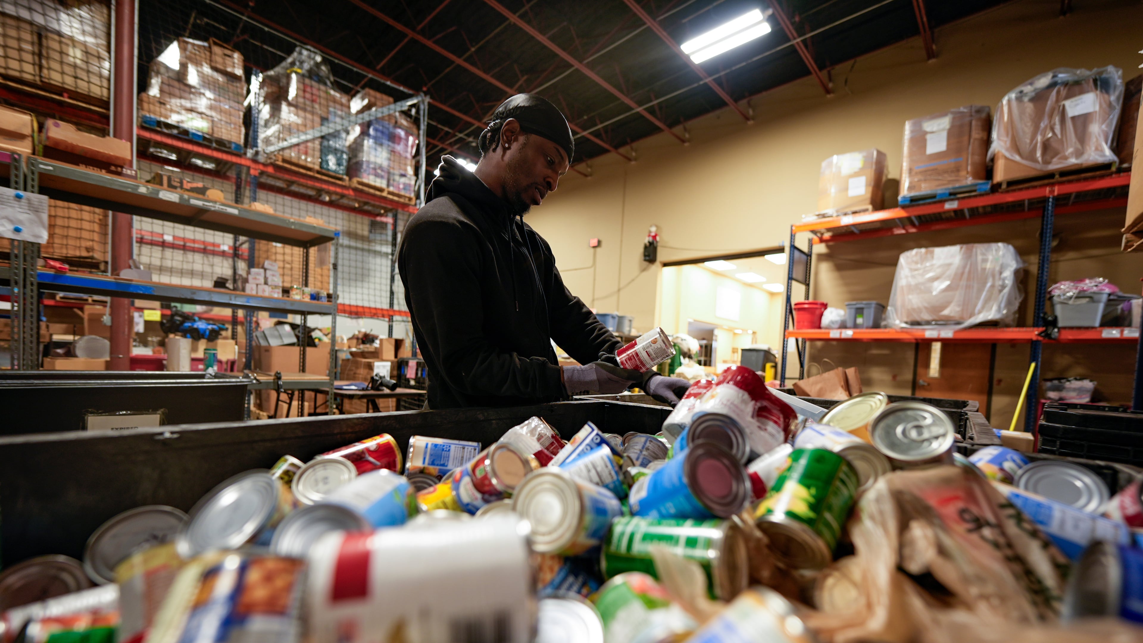 Volunteer Matthew Underwool works at MUST Ministries food distribution center, Monday, Nov. 3, 2025, in Marietta. (Mike Stewart/AP)
