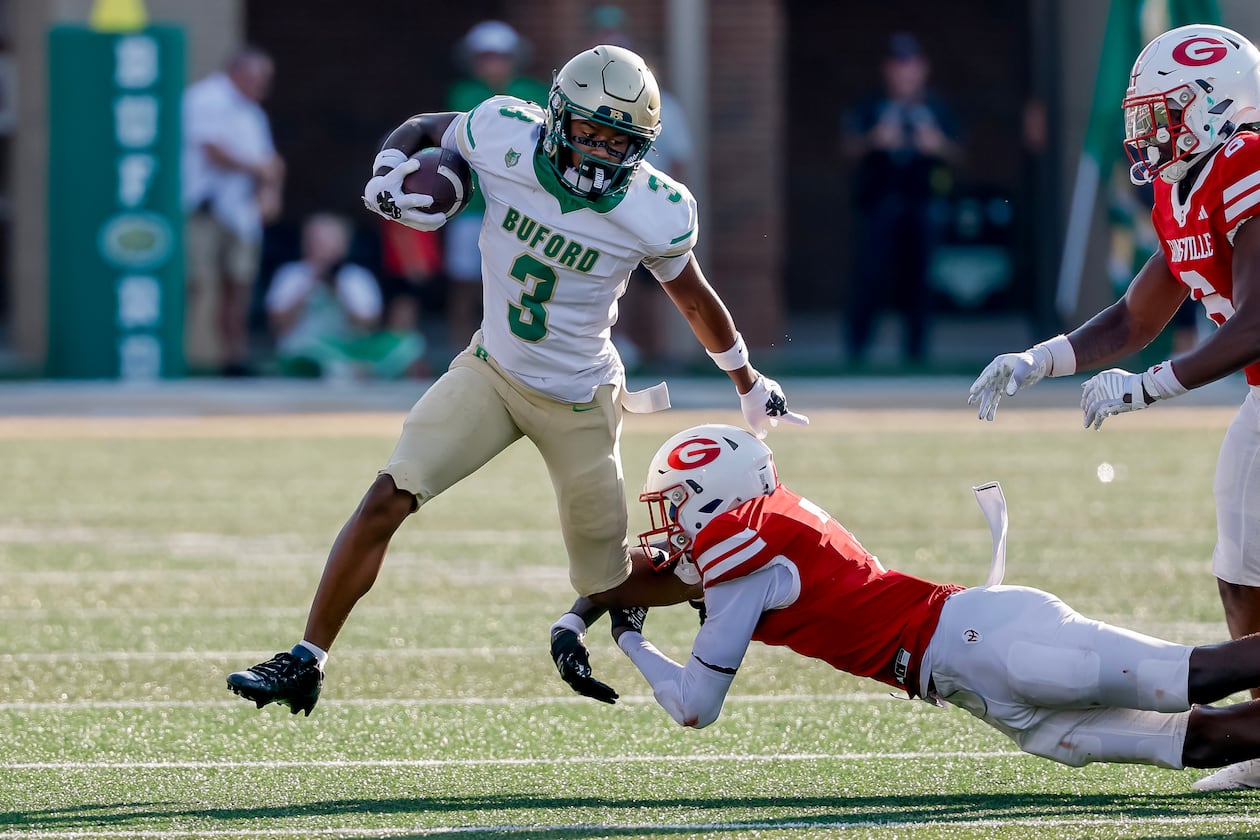 Buford's Ashton Thomas is tackled by Gainesville's Jeremiah Proctor during the first half of a high school football game between Buford and Gainesville, Saturday, Aug. 22, 2026, in Buford, Ga. (Erik S. Lesser for the AJC)