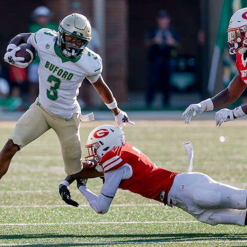 Buford's Ashton Thomas is tackled by Gainesville's Jeremiah Proctor during the first half of a high school football game between Buford and Gainesville, Saturday, Aug. 22, 2026, in Buford, Ga. (Erik S. Lesser for the AJC)