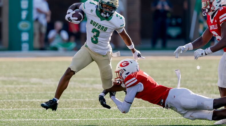 Buford's Ashton Thomas is tackled by Gainesville's Jeremiah Proctor during the first half of a high school football game between Buford and Gainesville, Saturday, Aug. 22, 2026, in Buford, Ga. (Erik S. Lesser for the AJC)