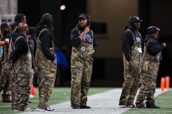 Carver-Columbus head coach Jarvis Jones talks with assistant coaches during the first half against Hapeville Charter in the Class 2A GHSA football championship at Mercedes-Benz Stadium, Tuesday, Dec. 16, 2025, in Atlanta. (Jason Getz/AJC)