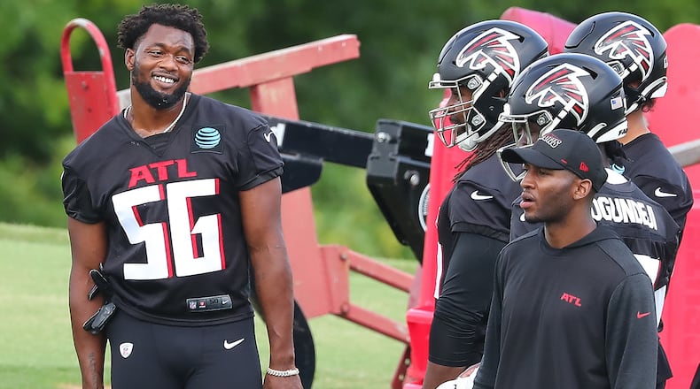 Falcons linebacker Dante Fowler (56) shares a laugh with teammates during team practice at minicamp Wednesday, June 10, 2021, in Flowery Branch. (Curtis Compton / Curtis.Compton@ajc.com)