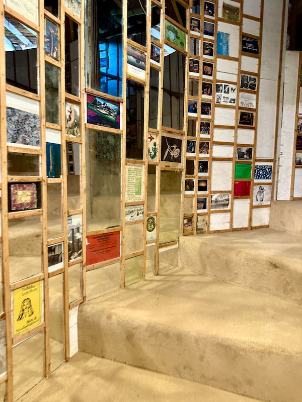 The spiral staircase that ascends to the top of The World's Folk Art Church is adorned with all the original mirrors, photographs and artwork Finster originally hung before the church closed down. Danielle Charbonneau/AJC