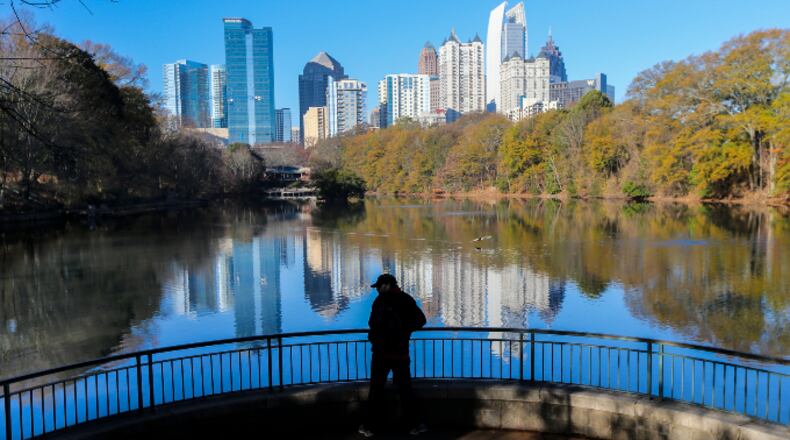 Midtown Atlanta’s skyline reflected in Lake Clare Meer at Piedmont Park on the first day of winter, Wednesday, Dec. 21, 2016.