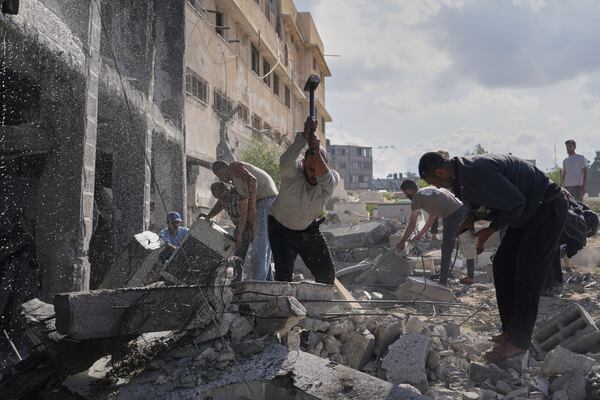 Palestinians try to clear the rubble of the Al-Ansar Mosque following an Israeli strike in Deir al-Balah, Gaza Strip, Monday, June 2, 2025. (AP Photo/Abdel Kareem Hana)