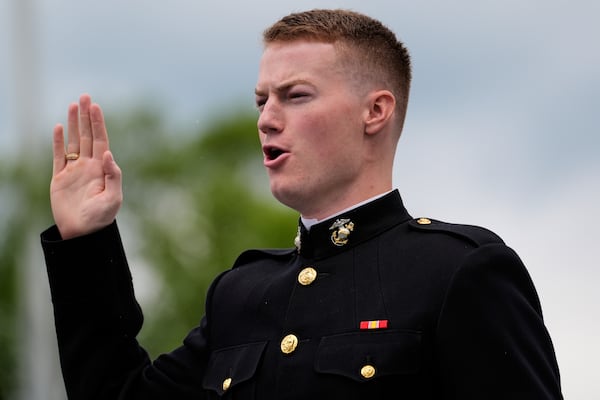 A graduate of the U.S. Naval Academy takes the Marine Corps oath during the academy's graduation and commissioning ceremony, at the U.S. Naval Academy in Annapolis, Md., Friday, May 23, 2025. (AP Photo/Stephanie Scarbrough)