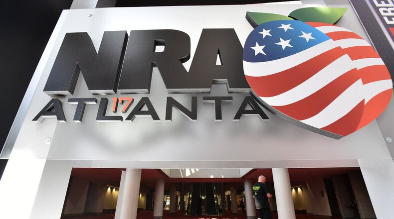 Workers put the finishing touches on the convention floor at the Georgia World Congress Center for the 146th NRA Annual Meetings and Exhibits in Atlanta, which continues through Sunday. (HYOSUB SHIN / HSHIN@AJC.COM)