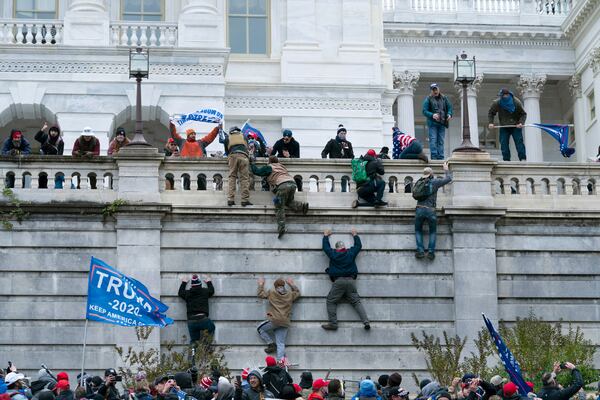 FILE - Supporters of then President Donald Trump climb the west wall of the the U.S. Capitol in Washington, Jan. 6, 2021. (AP Photo/Jose Luis Magana, File)