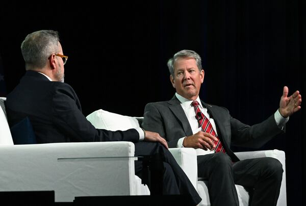 Gov. Brian Kemp (right) speaks as moderator Chris Clark, president and CEO of the Georgia Chamber, listens during the Georgia Chamber’s annual congressional luncheon Wednesday in Athens. (Hyosub Shin/AJC)