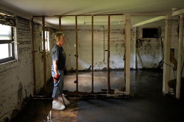 Debbie Sander looks at the damage to her mother's house in Ingram, Texas, Tuesday, July 8, 2025, after it was flooded with more than six feet of water during the Fourth of July flood. (Jay Janner/Austin American-Statesman via AP)