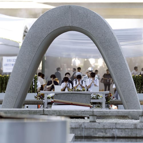Visitors pray in front of the cenotaph dedicated to the victims of the atomic bombing ahead of a ceremony to mark the anniversary of the bombing at the Hiroshima Peace Memorial Park in Hiroshima, western Japan Thursday, Aug. 6, 2026. (Mizuki Sakai/Kyodo News via AP)