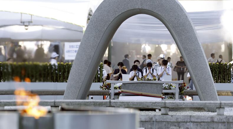 Visitors pray in front of the cenotaph dedicated to the victims of the atomic bombing ahead of a ceremony to mark the anniversary of the bombing at the Hiroshima Peace Memorial Park in Hiroshima, western Japan Thursday, Aug. 6, 2026. (Mizuki Sakai/Kyodo News via AP)
