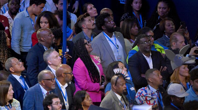 Georgia delegates including U.S. Congresswoman Nikema Williams (center) watch video screens during the second of the Democratic National Convention at the United Center, Tuesday, August 20, 2024, in Chicago, Illinois. (Hyosub Shin / AJC)