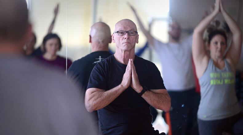 Ned McNamara, center, leads a yoga class at the Spokane Valley YMCA. He also teaches at Touchmark and is very involved as a search and rescue volunteer. (Jesse Tinsley/The Spokesman-Review/TNS)
