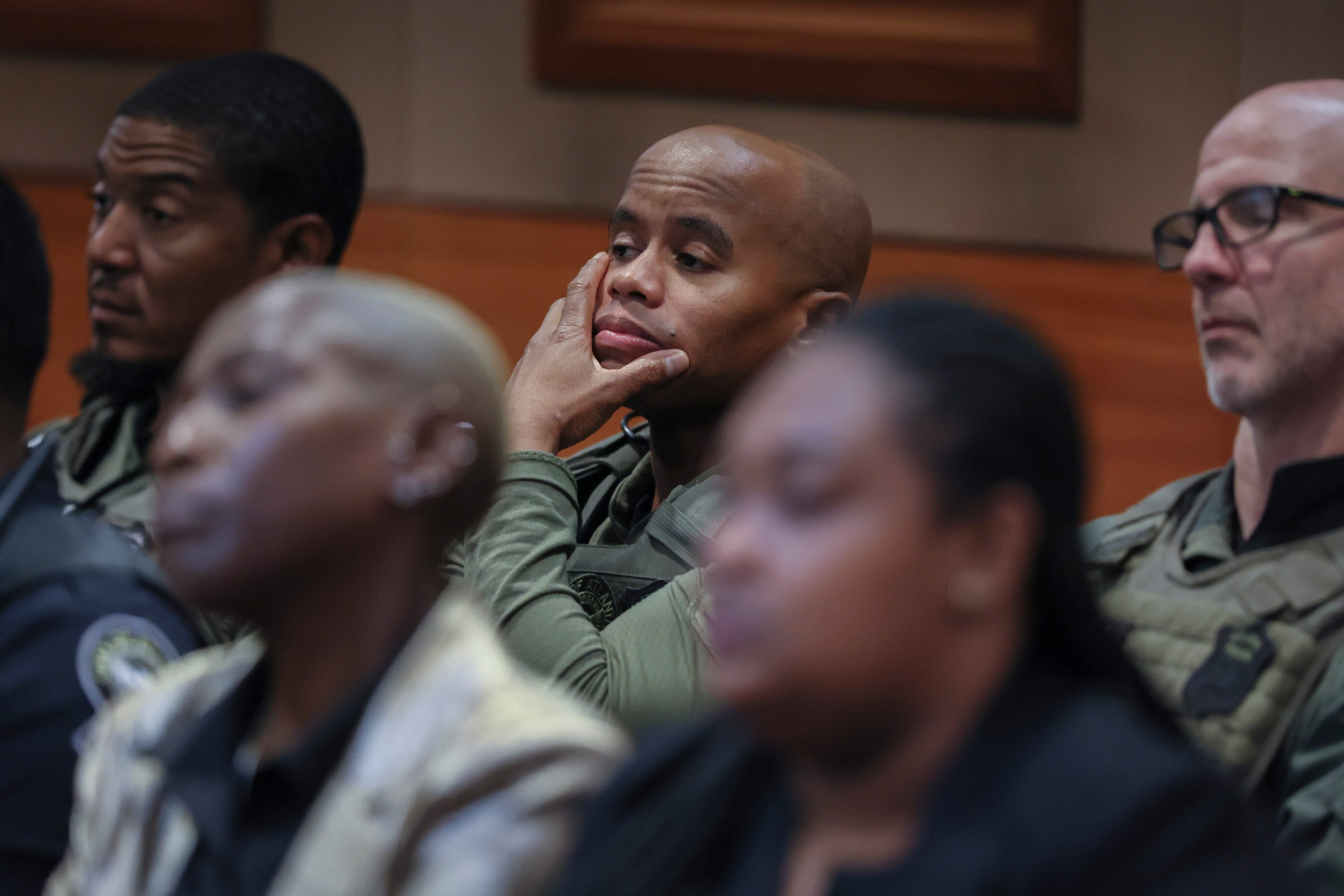Atlanta police officers look on in court Monday as the final defendant pleads guilty in Fulton County's long-running "Young Slime Life" case. Officer David Rodgers (center) was shot six times by Christian Eppinger in February 2022. (Jason Getz / AJC)