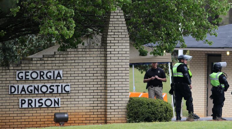 Corrections officers guard the entrance to the Georgia Diagnostic and Classification State Prison in advance of the scheduled execution of Joshua Bishop on Thursday evening, March 30, 2016. (Ben Gray / bgray@ajc.com)