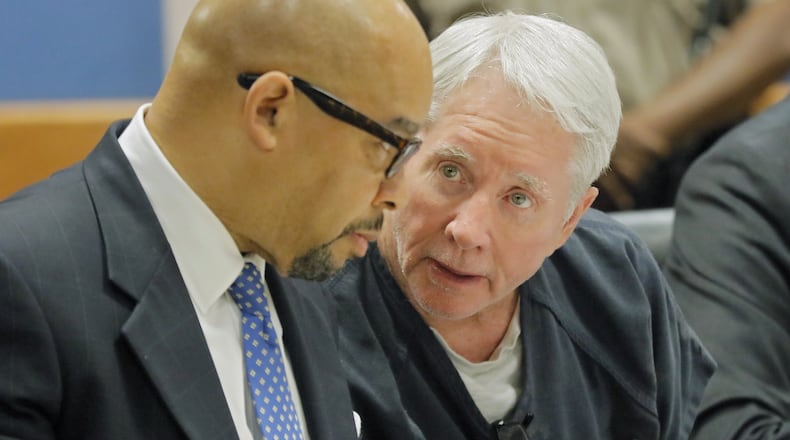 Claud “Tex” McIver confers with one of his attorneys, William Hill (left). Hill said he expects McIver to make bond and be released next week. BOB ANDRES /BANDRES@AJC.COM