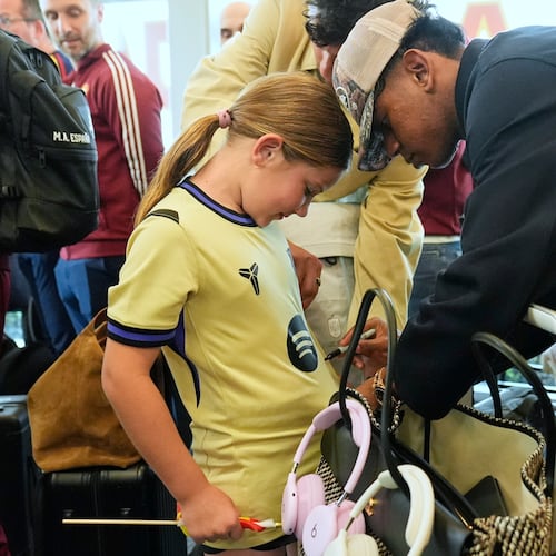 Spain midfielder Lamine Yamal, right, signs an autograph for Griffin Wamp, left, after arriving with teammates for the World Cup soccer tournament Friday, June 5, 2026, in Chattanooga, Tenn. (AP Photo/George Walker IV)