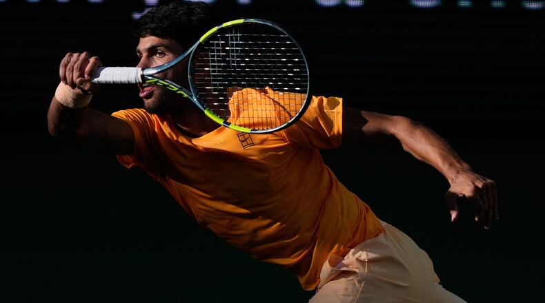 Carlos Alcaraz, of Spain, returns a shot against Daniil Medvedev, of Russia, during a semifinal match at the BNP Paribas Open tennis tournament, Saturday, March 14, 2026, in Indian Wells, Calif. (AP Photo/Mark J. Terrill)