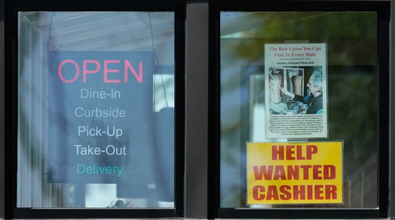 A hiring sign is displayed at a restaurant in Morton Grove, Ill., Thursday, May 14, 2026. (AP Photo/Nam Y. Huh)