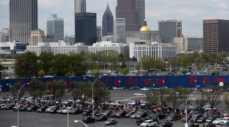 Early arriving fans tailgate under the Atlanta skyline Tuesday afternoon April 8, 2014 at Turner Field before the Braves home opener against the Mets. BEN GRAY / BGRAY@AJC.COM