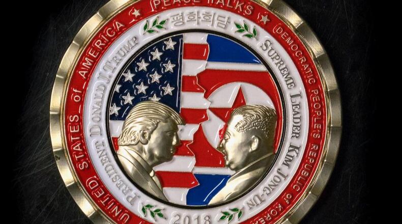 A coin for the US-North Korea summit is seen in Washington, DC, on May 21, 2018. - A commemorative coin featuring US President Donald Trump and North Korea's Kim Jong Un has been struck by the White House Communications Agency ahead of their summit meeting. The coin depicts Trump and Kim, described as North Korea's "Supreme Leader," in profile facing each other in front of a background of US and North Korean flags. The words "Peace Talks" are emblazoned at the top of the front of the coin with the date "2018" beneath. The summit is expected to take place in Singapore on June, 12, 2018. (Photo by STR / AFP)        (Photo credit should read STR/AFP/Getty Images)