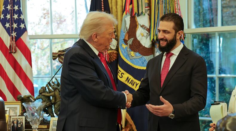 In this photo released by Syrian Presidency press office, President Donald Trump, left, shakes hands with Syria's President Ahmad al-Sharaa, at the White House in Washington, Monday, Nov. 10, 2025. (Syrian Presidency press office via AP)