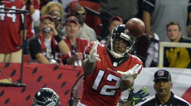 January 14, 2017 Atlanta - Atlanta Falcons wide receiver Mohamed Sanu (12) catches a touchdown pass over Seattle Seahawks cornerback Jeremy Lane (20) in the second half during the NFC divisional playoffs at the Georgia Dome on Saturday, January 14, 2017. Atlanta Falcons won 36-20 over the Seattle Seahawks. HYOSUB SHIN / HSHIN@AJC.COM