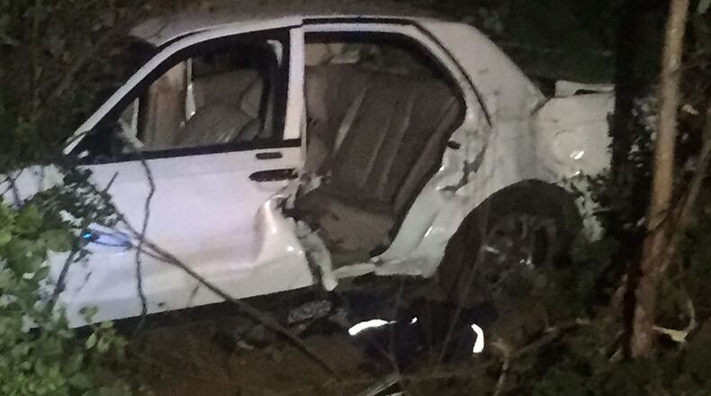 A passenger died when this car ran off a south DeKalb County road, hitting a parked car and pushing that car into the corner of a garage. (Credit: Channel 2 Action News)