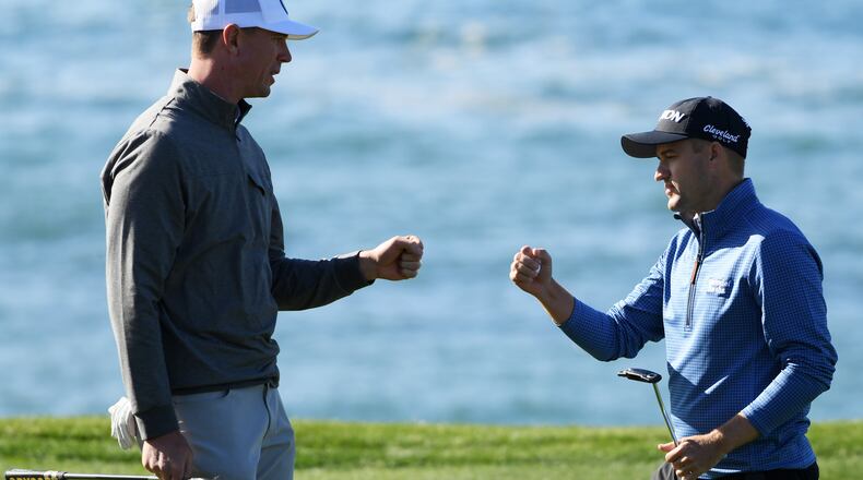 NFL player Matt Ryan and Russell Knox of Scotland bump fists on the eighth green during the third round of the AT&T Pebble Beach Pro-Am at Pebble Beach Golf Links on February 09, 2019 in Pebble Beach, California. (Photo by Harry How/Getty Images)