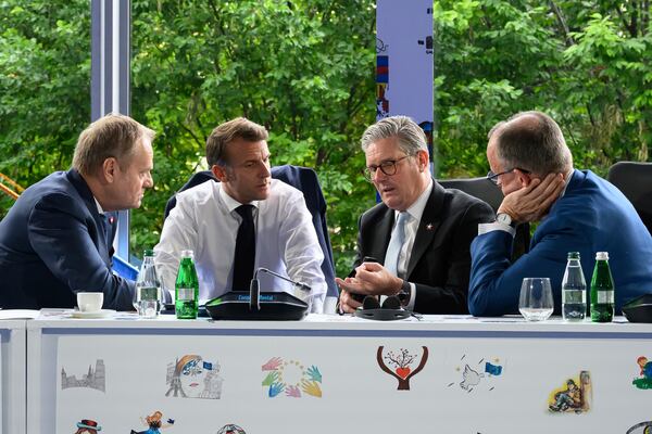 From left, Poland's Prime Minister Donald Tusk, France's President Emmanuel Macron, Britain's Prime Minister Keir Starmer and Germany's Chancellor Friedrich Merz speak during the Ukraine security meeting at the 6th European Political Community summit Friday May 16, 2025 in Tirana, Albania. (Leon Neal/Pool via AP)