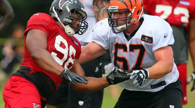 Falcons defensive end Cliff Matthews rushes against Bengals guard Mike Pollack during a joint practice on Tuesday, August 6, 2013, in Flowery Branch. CURTIS COMPTON / CCOMPTON@AJC.COM
