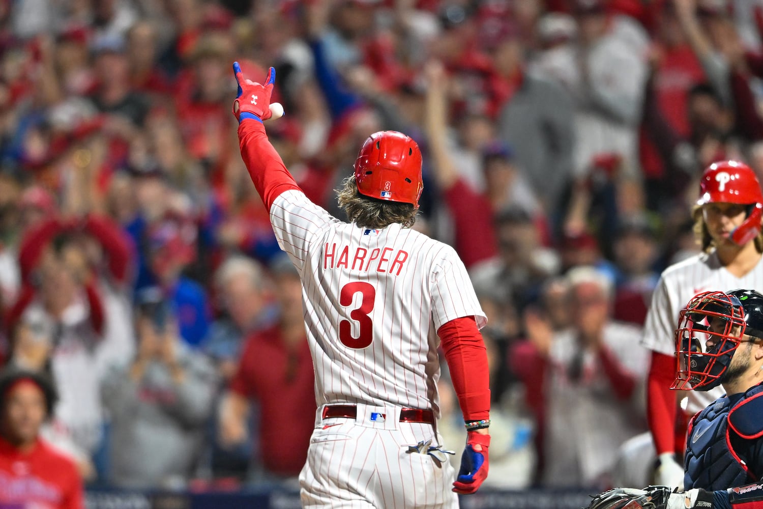 Philadelphia Phillies’ Bryce Harper signals to fans after hitting his second home run of the evening during the fifth inning of NLDS Game 3 against the Atlanta Braves in Philadelphia on Wednesday, Oct. 11, 2023.   (Hyosub Shin / Hyosub.Shin@ajc.com)