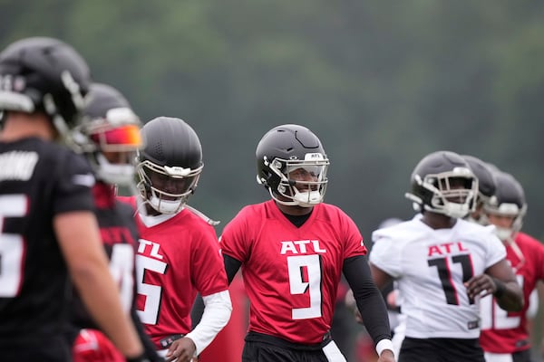 Atlanta Falcons quarterback Michael Penix Jr. (9) stretches during an NFL football training camp practice on Tuesday, May 27, 2025, in Flowery Branch, Ga. (AP Photo/Brynn Anderson)