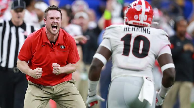 Georgia defensive coordinatory Dan Lanning and defensive lineman Malik Herring begin to celebrate after Richard LeCounte intercepted a Baylor pass in the final minutes to seal a 26-14 victory in the Sugar Bowl at the Superdome on Wednesday, January 1, 2020, in New Orleans. Curtis Compton ccompton@ajc.com