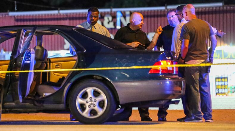 DeKalb police work the scene of a reportedly gang-related shooting that killed a teen girl in August. JOHN SPINK /JSPINK@AJC.COM