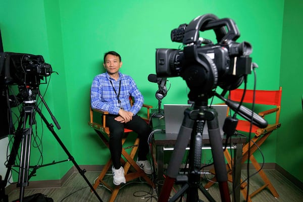 Vuthy Tha, a Cambodian reporter at Radio Free Asia who spent 7 years in a Thai refugee camp before arriving in the United States, poses for a portrait in the podcast room, Tuesday, April 1, 2025, at the RFA office in Washington. (AP Photo/Rod Lamkey, Jr.)